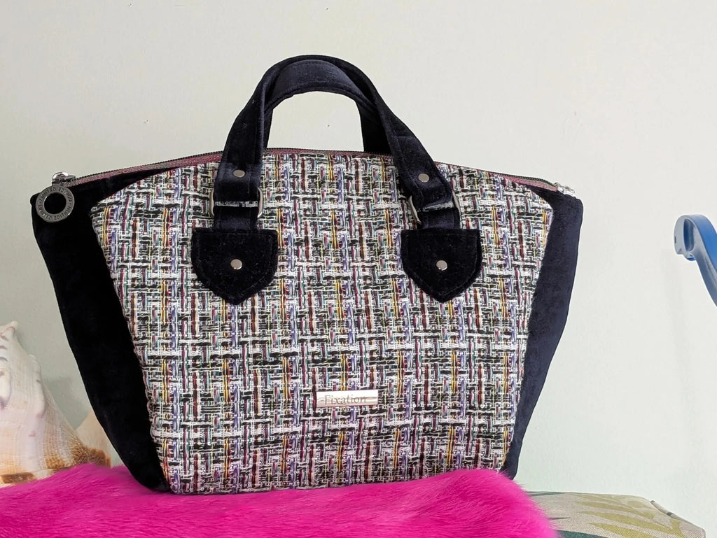 Fixation Fibre and Function structured handbag featuring a multi-colored tweed panel and black velvet side accents.