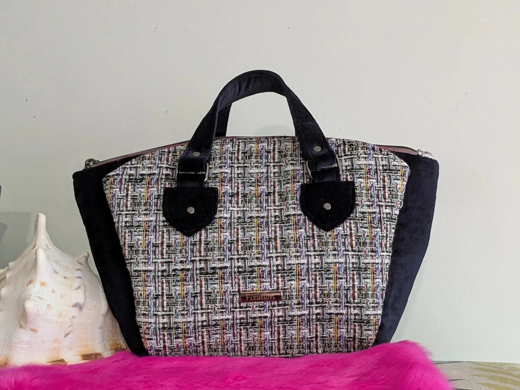 Fixation Fibre and Function structured handbag featuring multi-colored tweed, black velvet sides, and velvet handles.