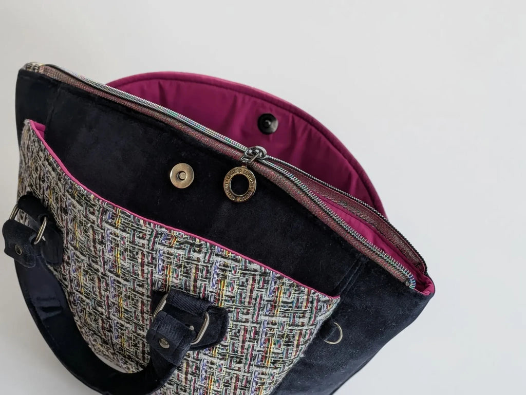 Fixation Fibre and Function structured handbag with multi-colored tweed, black velvet panels, and fuchsia interior.
